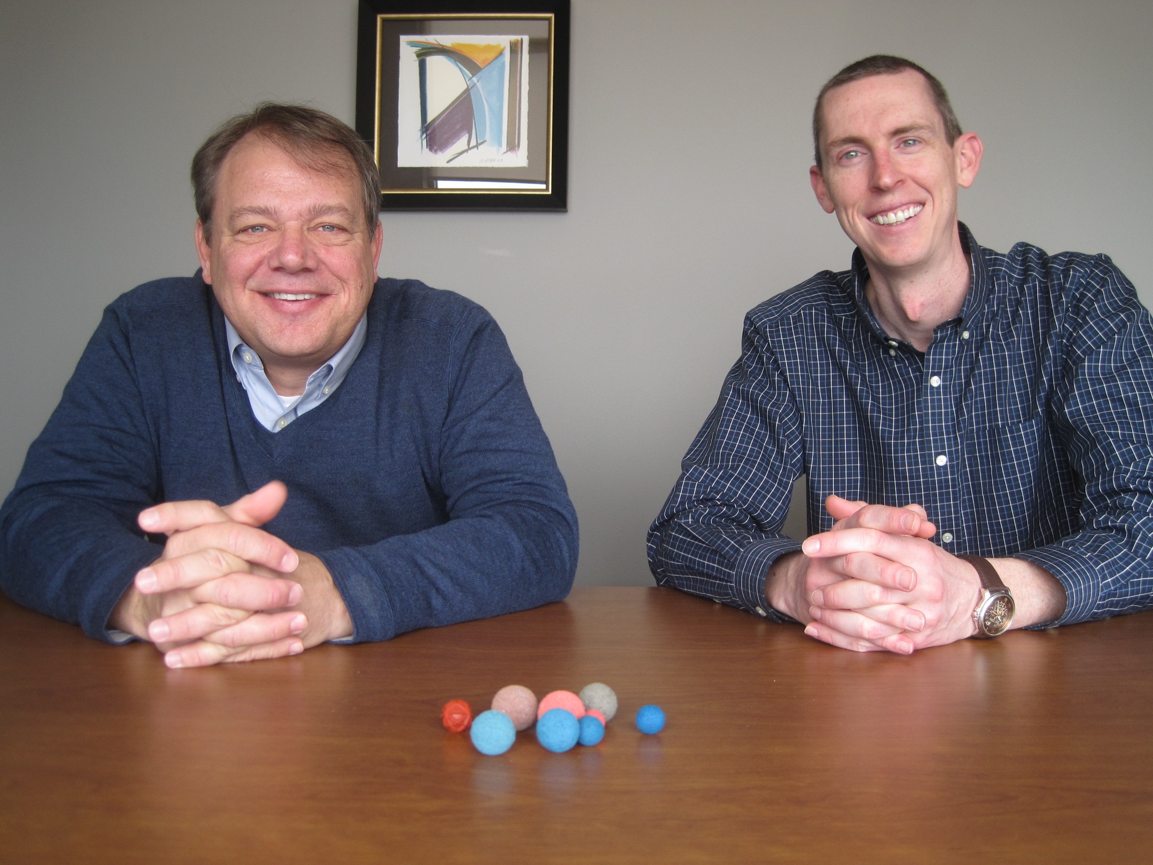 Innovas Technologies co-founders Chuck Dirks (left) and Mike Crocker show off the spongy balls used in their company’s Helios Automatic Tube Cleaning System to clean biofilm and other deposits blocking thermal energy transfer in heat exchanges. PHOTO DAVE DEWITTE