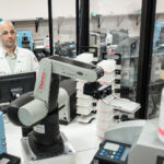 Production scientist Rob Halden operates a robotic microplate handling arm at Integrated DNA Technologies in Coralville Wednesday, August 8, 2012.