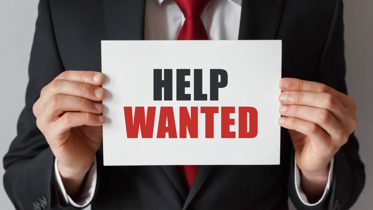businessman-holding-card-with-text-help-wanted (1)