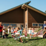 Creekside Forest School students and staff participated in a ribbon-cutting for the new school at the Indian Creek Nature Center Thursday, Sept. 16, 2021. LIZ ZABEL PHOTO/INDIAN CREEK NATURE CENTER