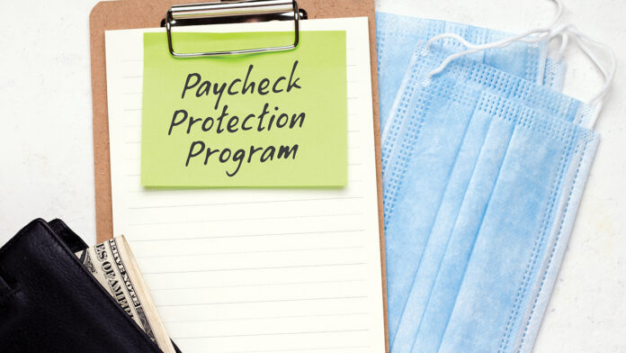 PPP Loan Salary Protection Program Concept. Wallet with money on an empty form. White background. Copy space