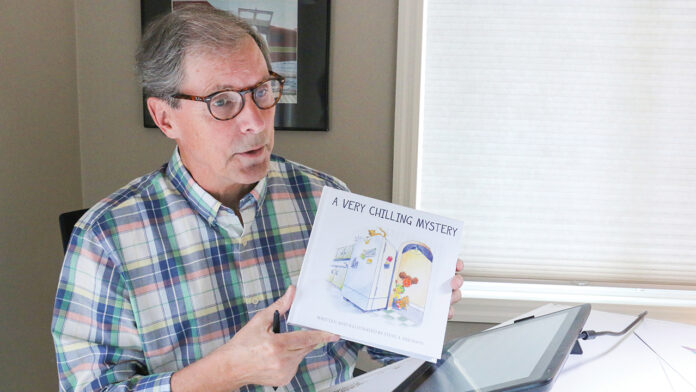 Steve Erickson shows off his new children’s book, “A Very Chilling Mystery.”