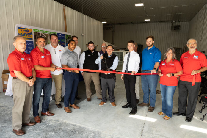 1-800-HANSONS employees and Cedar Rapids Metro Economic Alliance representatives participate in a ribbon cutting for the new Cedar Rapids location of the company on Aug. 19, 2022. CREDIT 1-800-HANSONS