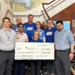 Courage Ride board members present a check for $65,000 to the Holden Comprehensive Cancer Center Sarcoma Research Program at the University of Iowa Hospitals and Clinics
