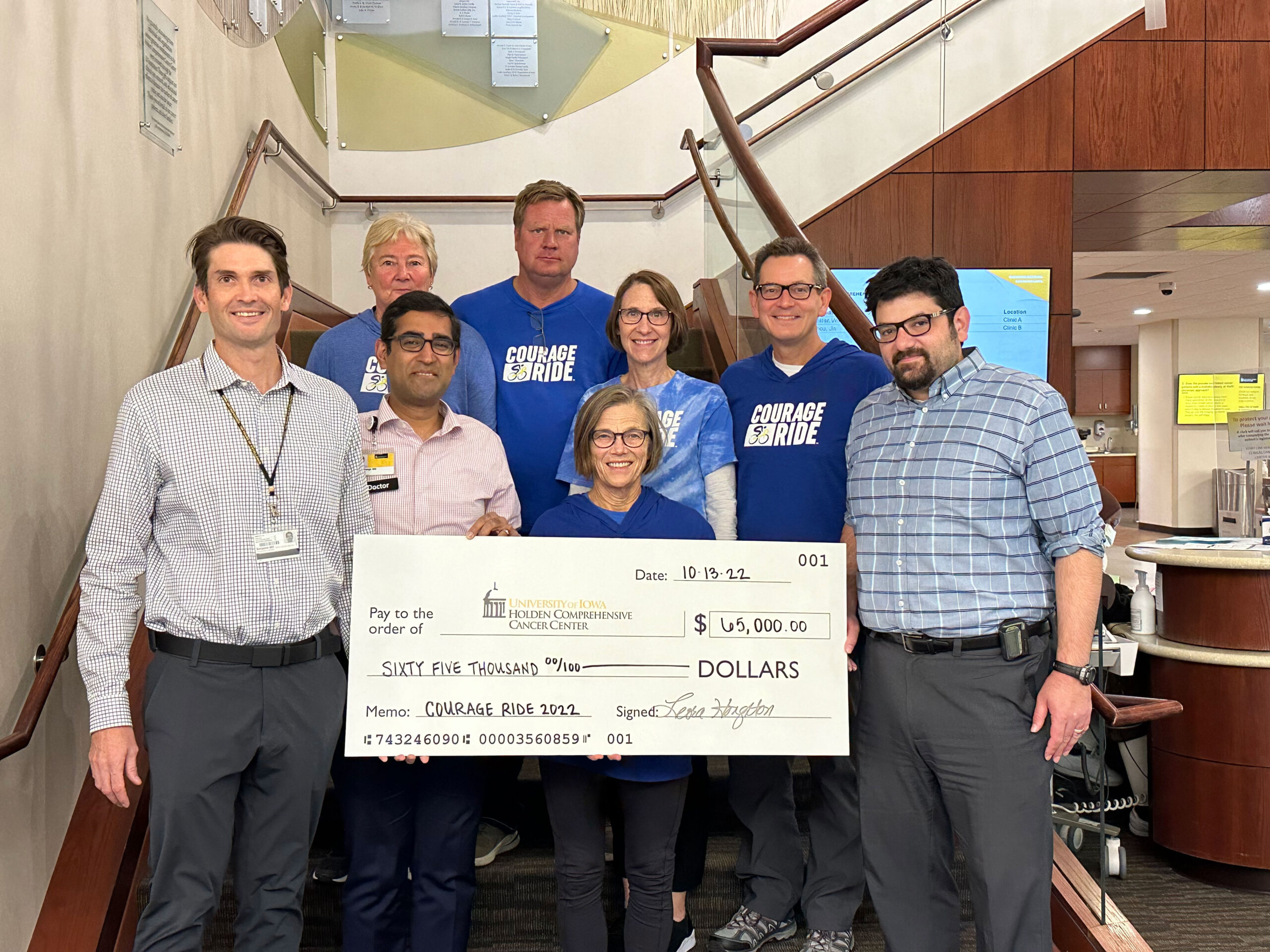 Courage Ride board members present a check for $65,000 to the Holden Comprehensive Cancer Center Sarcoma Research Program at the University of Iowa Hospitals and Clinics