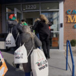 People participate in AMPERAGE Marketing & Fundraising holiday elves campaign.