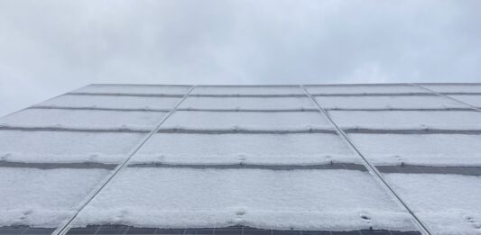 A snow-covered 240 solar panel array alongside the North Liberty Streets Department, installed by Moxie Solar. CREDIT NOAH TONG