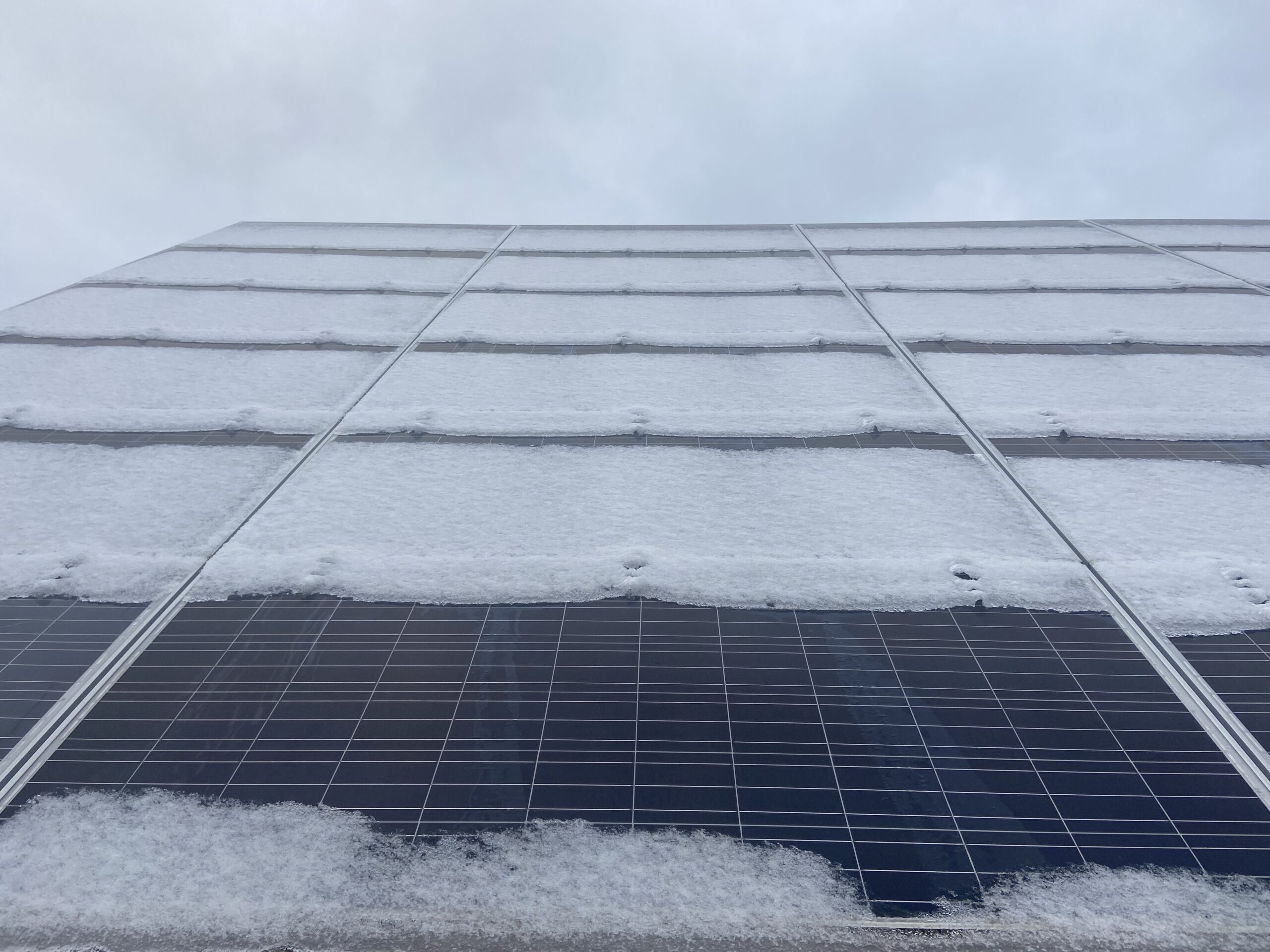 A snow-covered 240 solar panel array alongside the North Liberty Streets Department, installed by Moxie Solar. CREDIT NOAH TONG