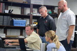 Brandon Yoder (left), founder of Green Transitions in Vinton, was acquired in 2016 by Moxie. North Liberty Mayor Chris Hoffman, Jenn Hall, and Vice President of Moxie Solar Illinois Blair Gretter. Photo taken in 2016. CREDIT CHASE CASTLE