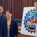 Local officials presented Coralville's logo and theme for its overnight RAGBRAI stop in July. CREDIT NOAH TONG