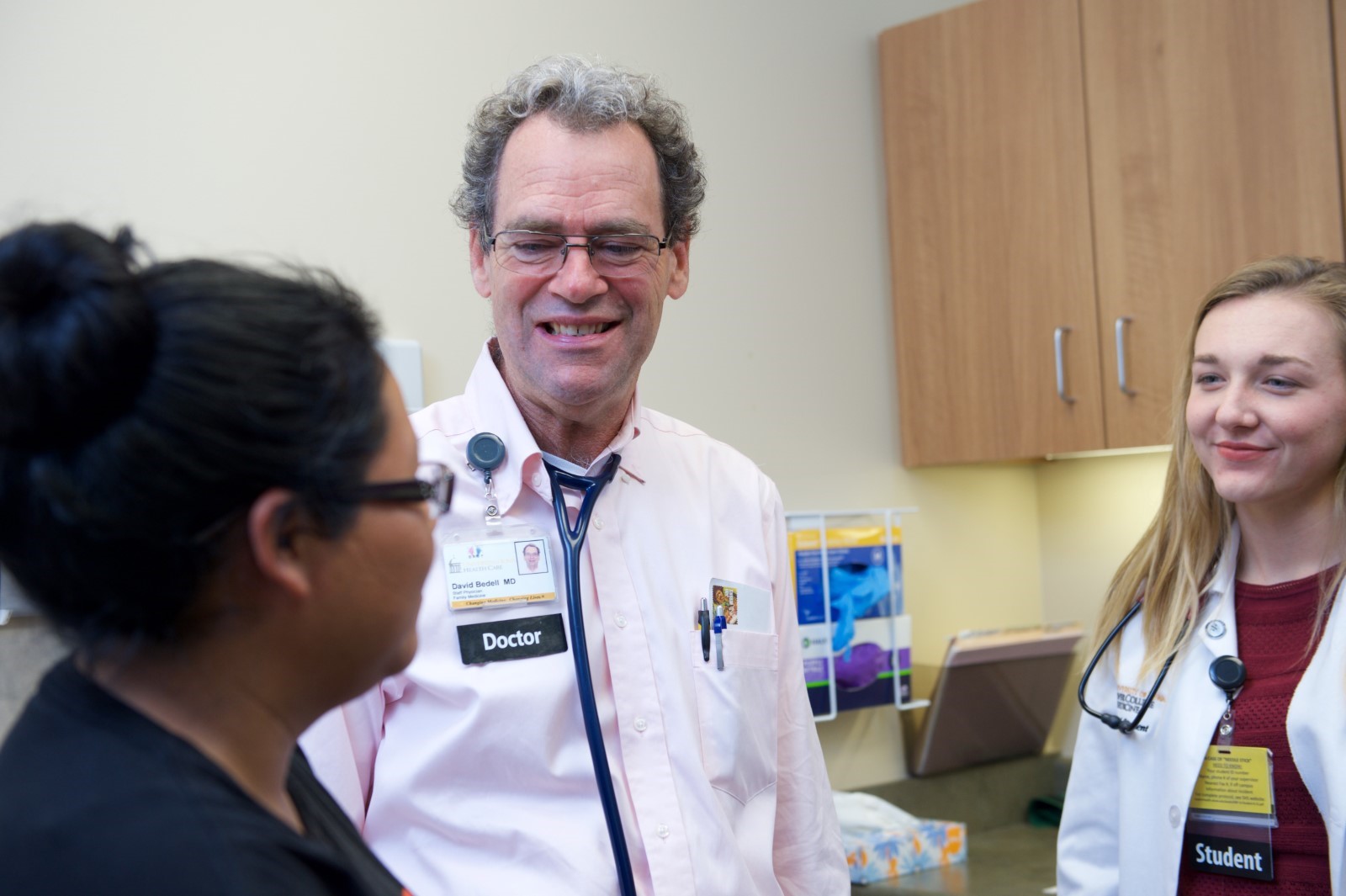 Family medicine physician, David Bedell, MD, attends to patient with a medical student. CREDIT UI HEALTH CARE