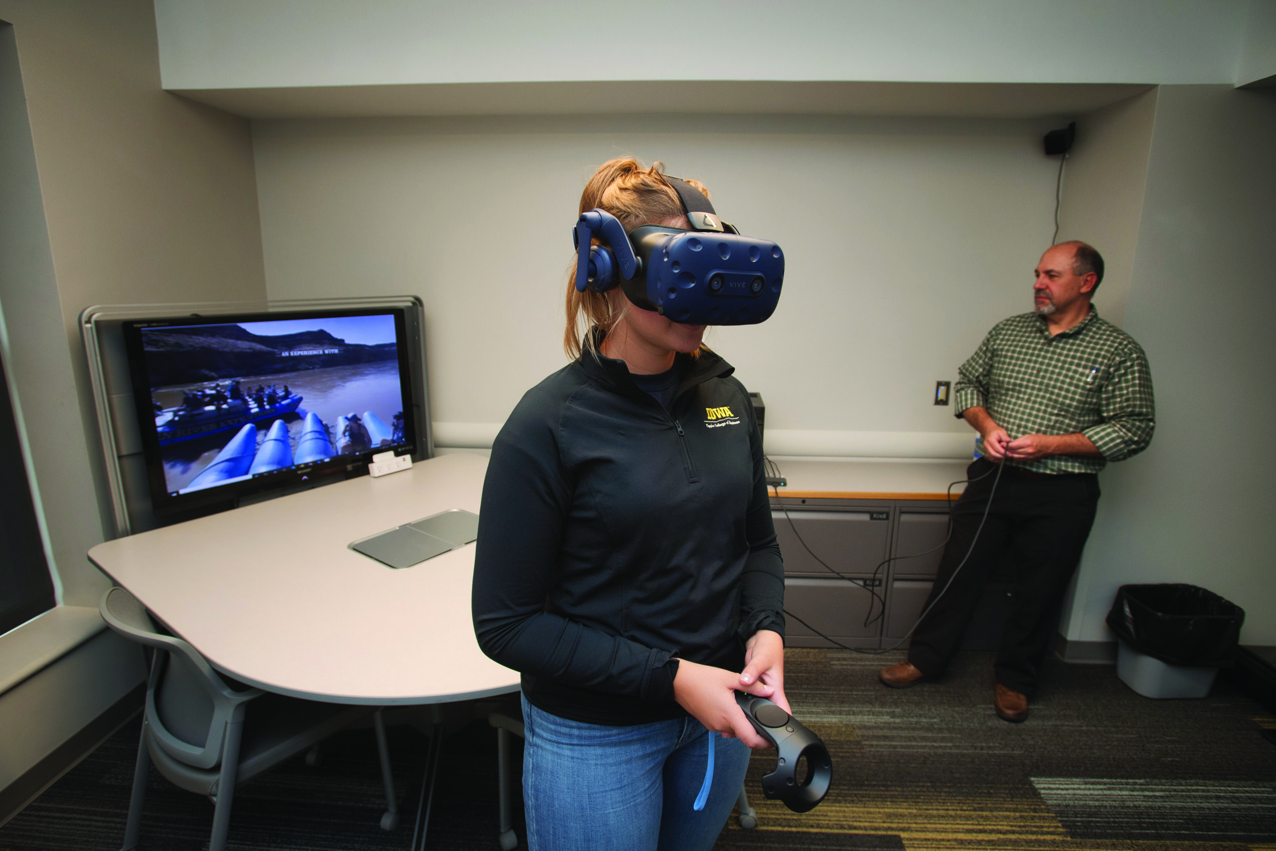 Jim Chaffee and Tippie student Isabel Anderson work with some of the college’s virtual reality technology.