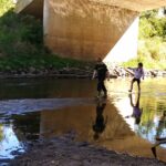 Students taking part in Indian Creek Nature Center's Fresh Air Academy play in water on the center's land. CREDIT INDIAN CREEK NATURE CENTER