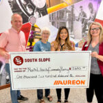 The North Liberty Community Pantry is presented with a $1,600 grant from South Slope Communications and Auroeon.