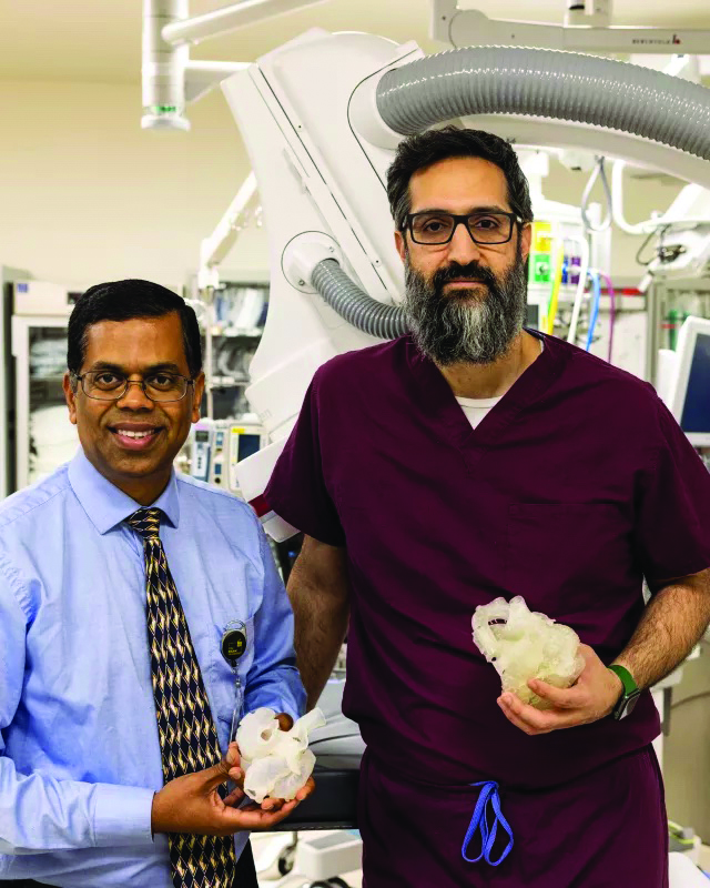 From left to right: Dr. Ravi Ash- wath and Dr. Osamah Aldoss hold 3D hearts printed at UIHC. CREDIT UNIVERSITY OF IOWA HEALTH CARE