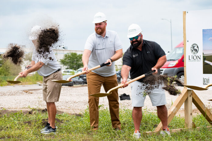 Palestra Sports Complex owner and lead developer of Solomon's Landing, Brandon Pratt (right) throws the first shovelful of dirt during the groundbreaking ceremony Thursday.