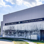 A mural commemorating the 150th anniversary of Coralville is seen on the side of Randy’s Flooring at 401 Second St. on July 26. CREDIT ELEANOR HILDEBRANDT