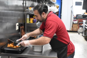 Mr. Nawaz in the kitchen of his restaurant. He hopes to operate a food truck someday as well. CREDIT ANNIE BARKALOW