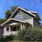 emma goldman clinic A green and white craftsman-style house