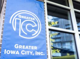 The Greater Iowa City, Inc. blue banner displays its new logo.