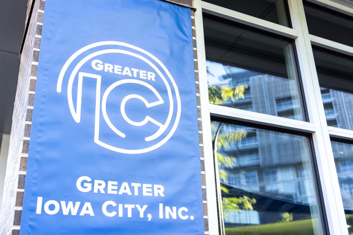 The Greater Iowa City, Inc. blue banner displays its new logo.