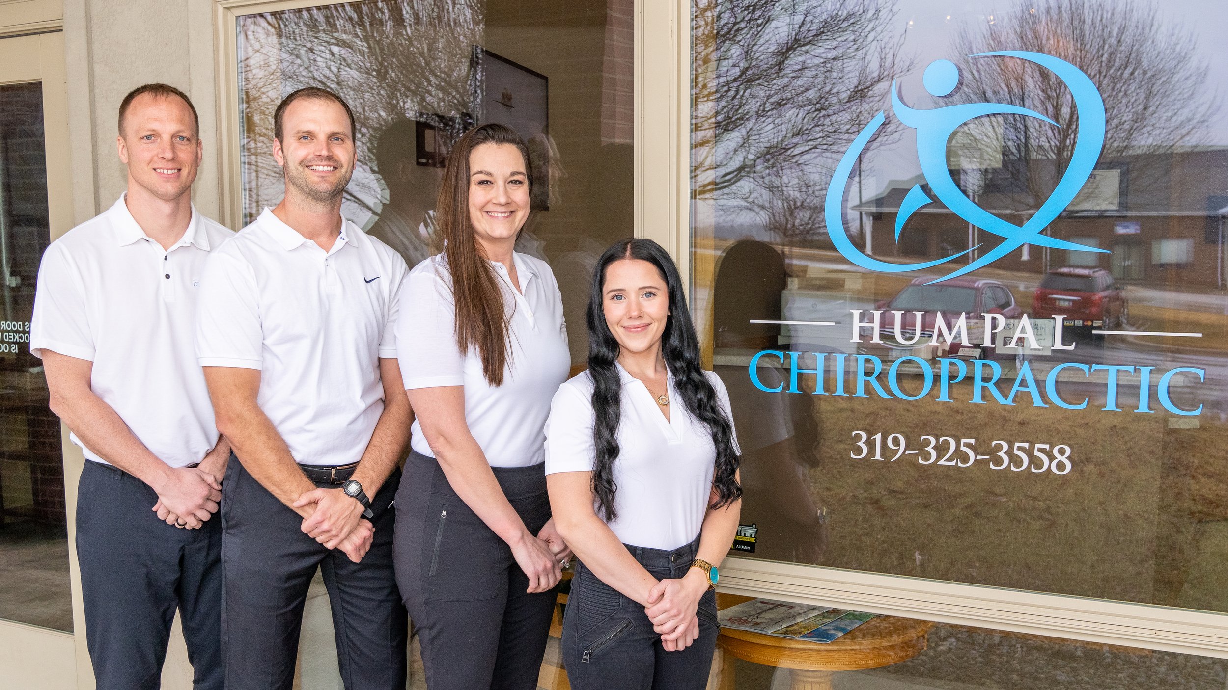 Humpal Chiropractic staff stand in front of the clinic.