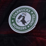 A barista dons a Starbucks Workers United sticker.