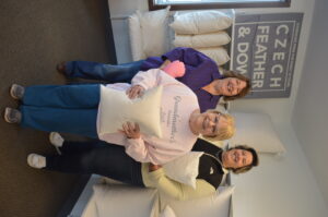 Dawn Schorg and her daughter Brittany Schorg, back row, and former owner Cookie Vanous, Dawn’s mother, are shown in the new location of Czech Feather & Down, 5907 16th Ave. SW, in Cedar Rapids.