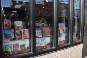 Colorful holiday books grace the display window of Prairie Lights Books, located at 15 S. Dubuque St. CREDIT ANNIE BARKALOW