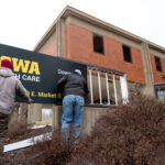Signage is updated at University of Iowa Health Care Medical Center Downtown on Wednesday, Jan. 31, 2024, on the day that ownership of Mercy Iowa City officially transitioned to UI Health Care.