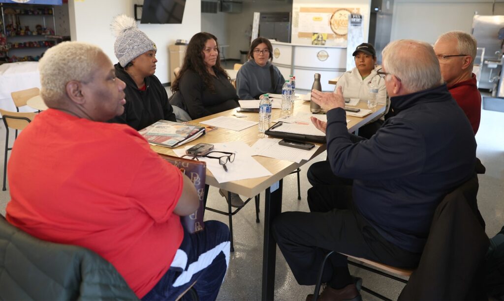 Business owners from the South of 6 Business District in Iowa City sit in on a mini-Venture school session Jan. 8.
