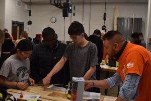 Northwest Junior High Industrial Tech students get some help from Matt Austin, manager of the Cedar Rapids Home Depot.