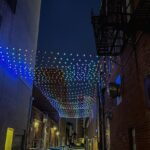 A string of RGB lights run the length of an alley in downtown Iowa City. The Iowa City Downtown District is boosting an initiative to keep the area clean, safe and vibrant by installing lights in dim areas.