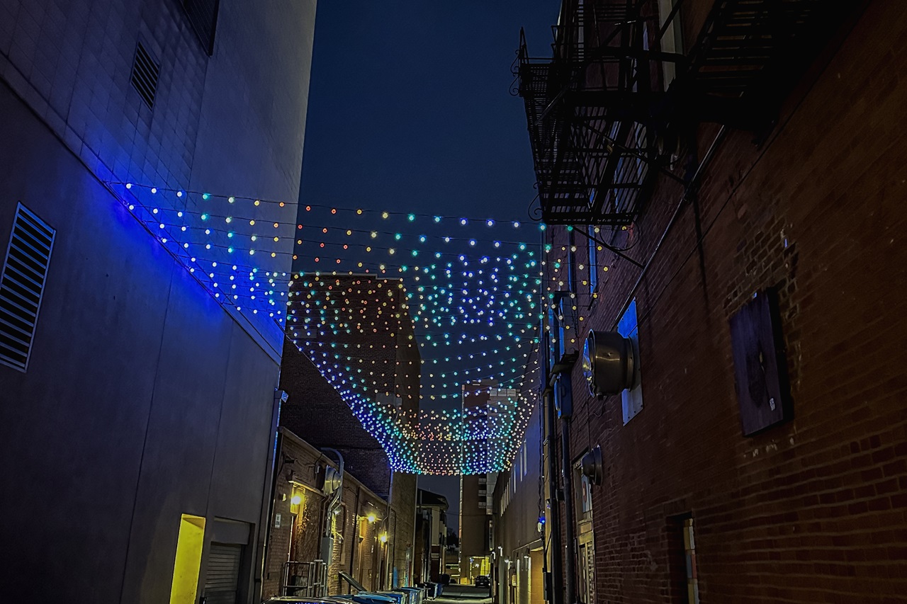 A string of RGB lights run the length of an alley in downtown Iowa City. The Iowa City Downtown District is boosting an initiative to keep the area clean, safe and vibrant by installing lights in dim areas.