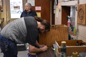 Ethan Woodsmall assists a customer at the WCDC Can Redemption and Shredding Center. 