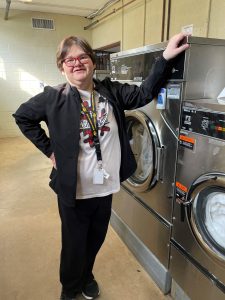 Stacy Hodgell, employee of the United Presbyterian Home in Washington, stand next to the many laundry machines that she oversees during the day. 