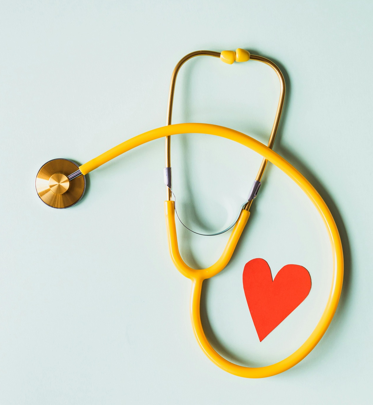 Yellow stethoscope with a red heart under it