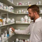 Aaron McDonough browses through prescription drugs at Towncrest Wellness Apothecary.