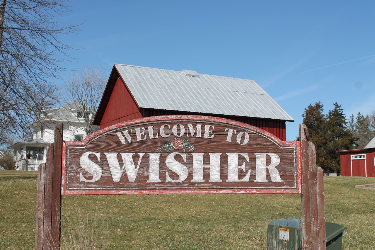 A sign marking Swisher city limits on 120th Street NW greets visitors.