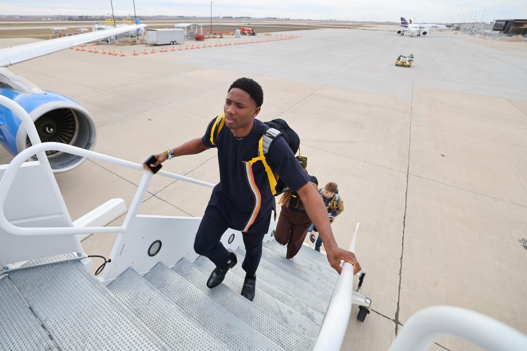 Precious Irivi, followed by other UI track and field student athletes, boards a chartered plane at the Eastern Iowa Airport in Cedar Rapids on Wednesday, Feb. 21, 2024. CREDIT STEPHEN MALLY/ UI ATHLETICS