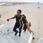 Precious Irivi, followed by other UI track and field student athletes, boards a chartered plane at the Eastern Iowa Airport in Cedar Rapids on Wednesday, Feb. 21, 2024. CREDIT STEPHEN MALLY/ UI ATHLETICS