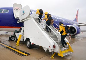 Iowa Women's Basketball players board an airplane as they depart for the NCAA Basketball Tournament on Wednesday, March 17, 2021. STEPHEN MALLY/UI ATHLETICS