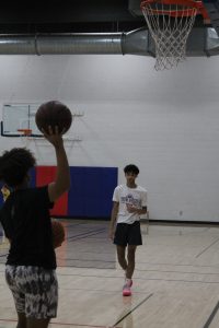 Two youths play basketball in the Coralville Recreation Center gym. City officials and residents would like to see a mixed-use space that could accommodate volleyball, basketball and pickleball. 