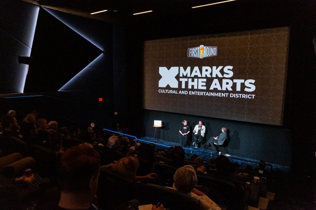 John Schickendanz, Executive Director of The Englert Theatre, and Tammie Walker, Director of the University of Iowa School of Music, address the crowd at a special First Round celebration hosted at FilmScene at The Chauncey on March 27.