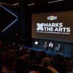 John Schickendanz, Executive Director of The Englert Theatre, and Tammie Walker, Director of the University of Iowa School of Music, address the crowd at a special First Round celebration hosted at FilmScene at The Chauncey on March 27.
