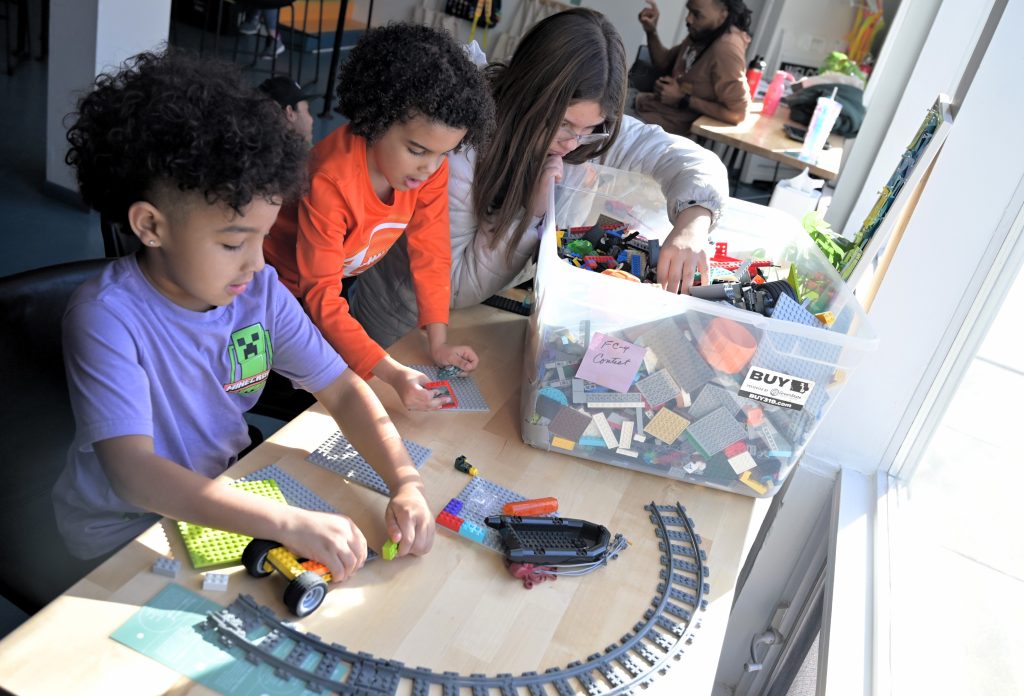 Young participants work with LEGO-based projects during a CoderDojo held at Wellington Heights Community Church in Cedar Rapids in February. Cedar Rapids-based NewBoCo has been offering a number of learning opportunities, including CoderDojos and Code 101s, in public spaces throughout the community in an effort to make them more accessible. CREDIT NEWBOCO