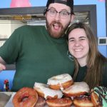 Glazed and Infused owners with donuts