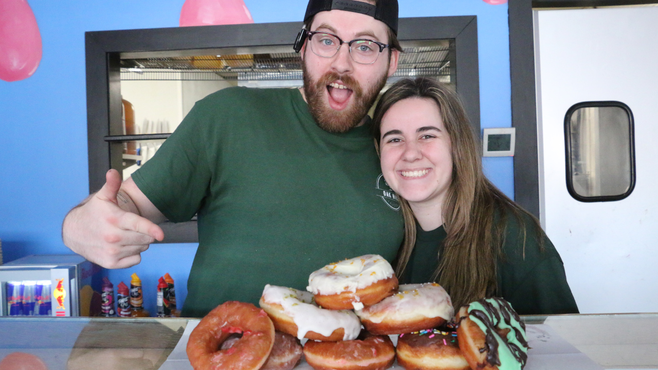 Glazed and Infused owners with donuts