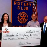 Founder and President Bart Woods and team member Ann Legree accept a $100,000 donation. They were presented with a check by 2023-2024 Cedar Rapids Rotary Club President Joe Lock.