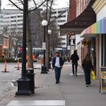 A pedestrian walks the sidewalk on a portion of Dubuque Street in Iowa City. The city and Iowa City Downtown District are partnering to contract Block by Block, a national cleaning firm that specializes in keeping downtown area clean and safe.